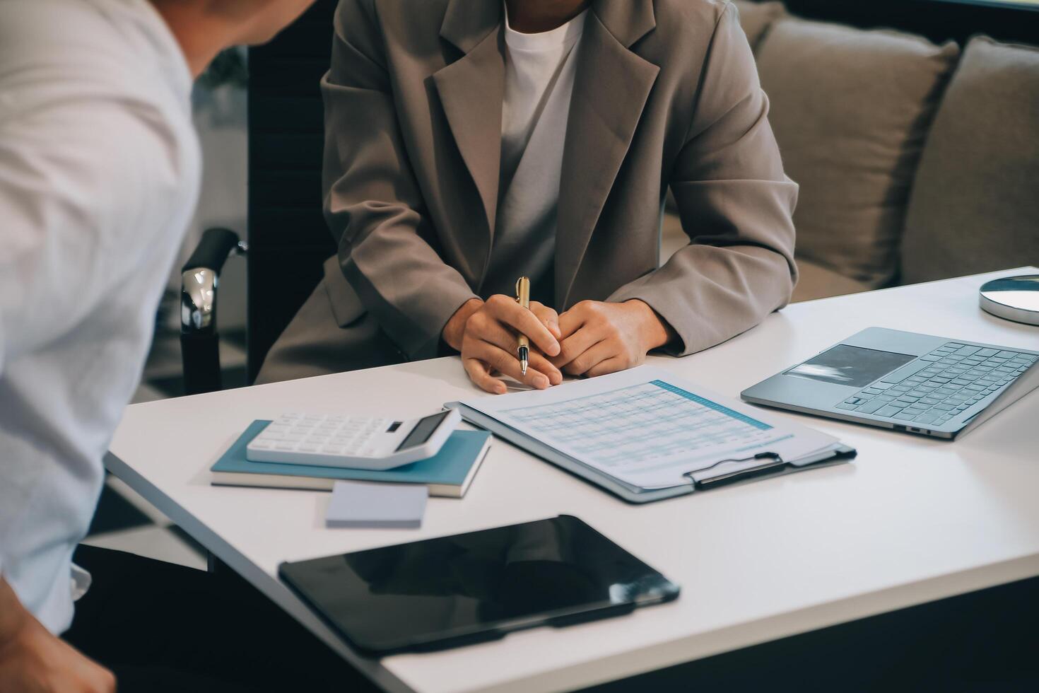 Business team working with new startup project plan and discussion information for financial strategy with laptop and digital tablet in a modern business lounge. photo