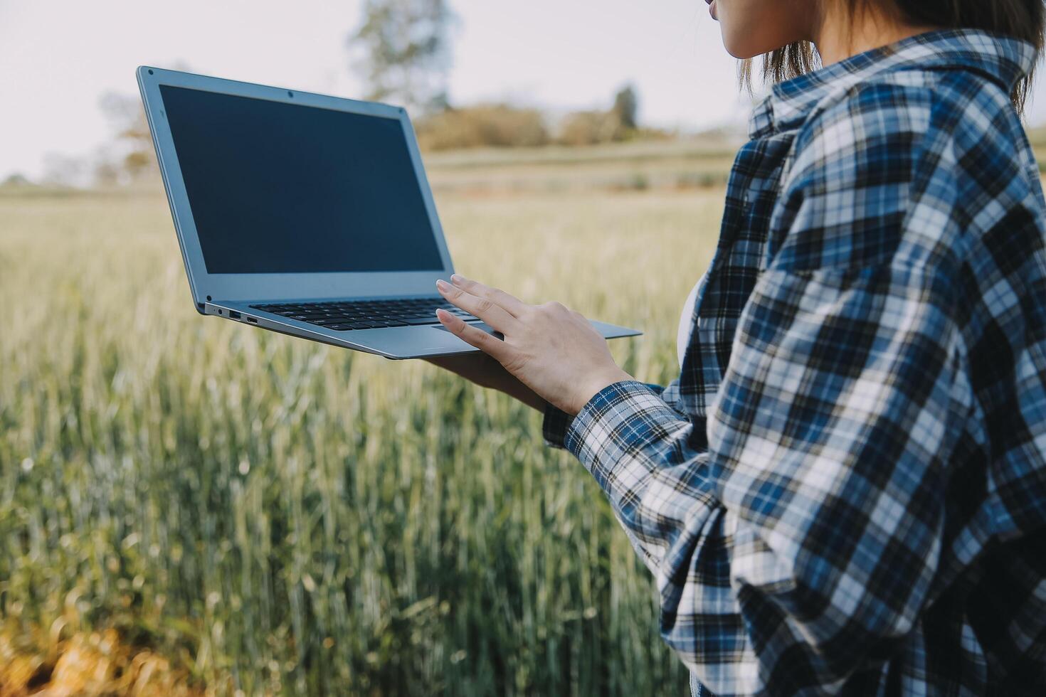 Smart farm. Farmer with tablet in the field. Agriculture, gardening or ecology concept. Harvesting. Agro business. photo