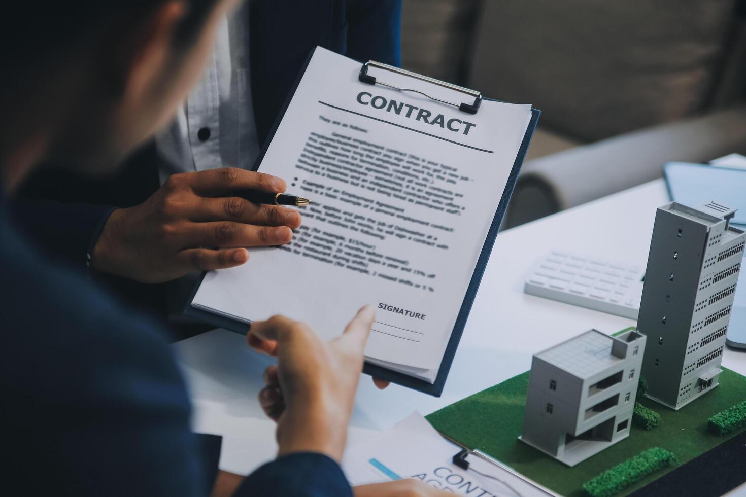 Real estate agent talked about the terms of the home purchase agreement and asked the customer to sign the documents to make the contract legally, Home sales and home insurance concept. photo