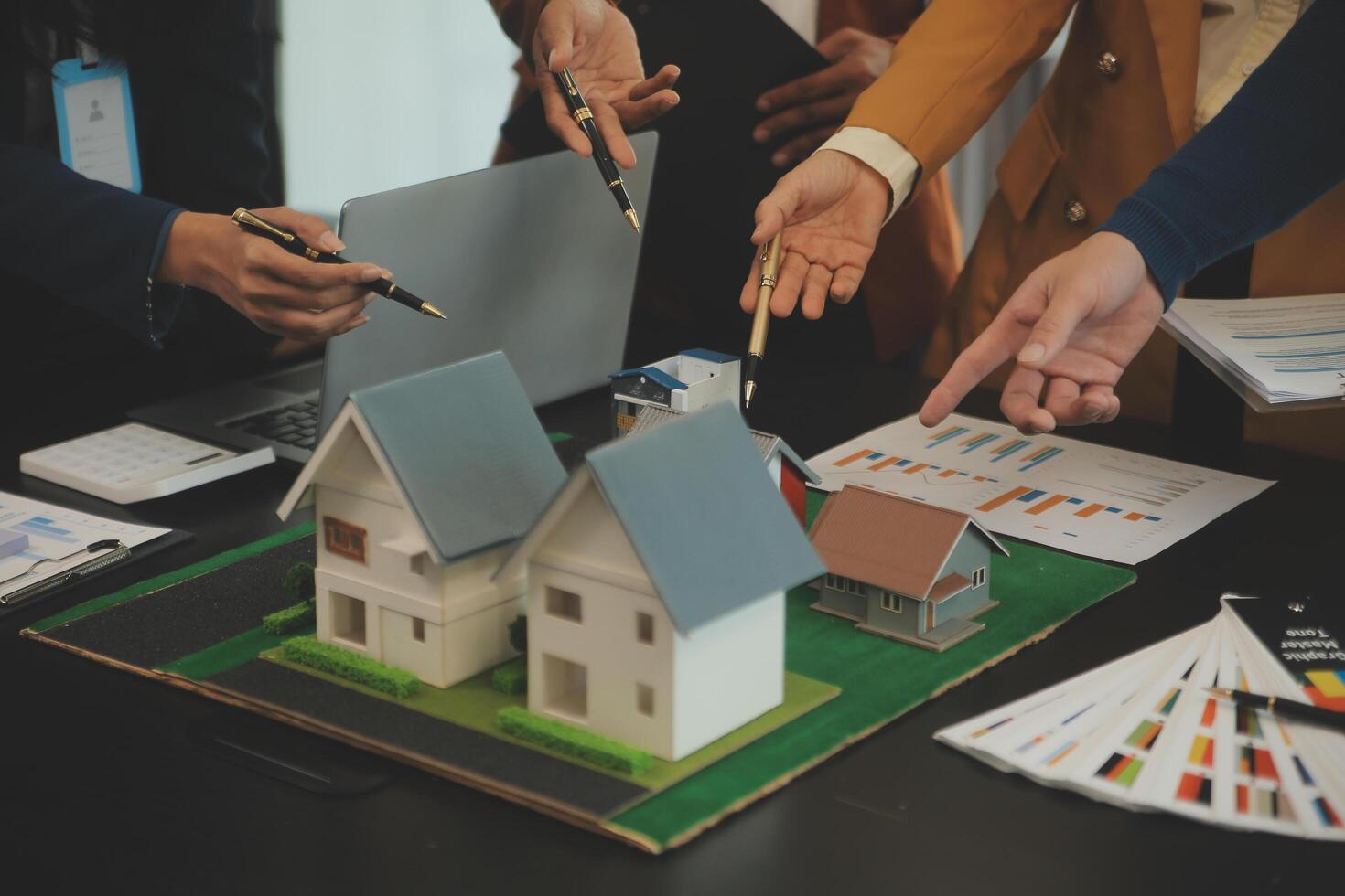 Team of architectures and businessmen discussing and brainstorming on floor plan modification for real estate investment and housing development project photo