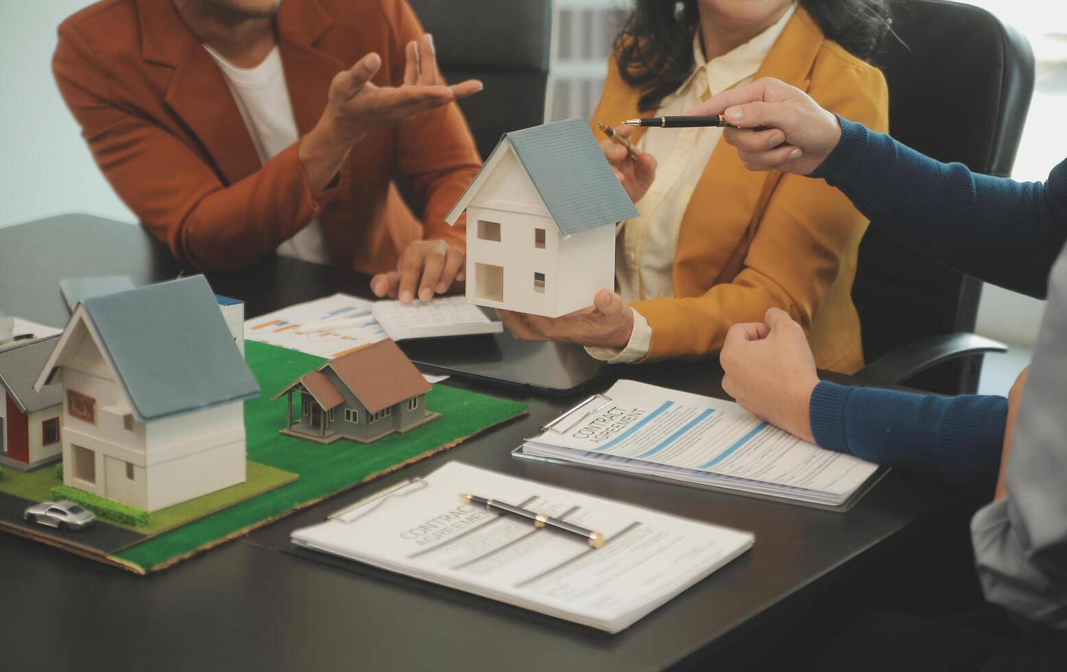 Team of architectures and businessmen discussing and brainstorming on floor plan modification for real estate investment and housing development project photo