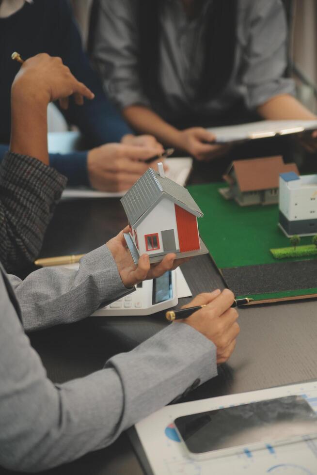 Team of architectures and businessmen discussing and brainstorming on floor plan modification for real estate investment and housing development project photo
