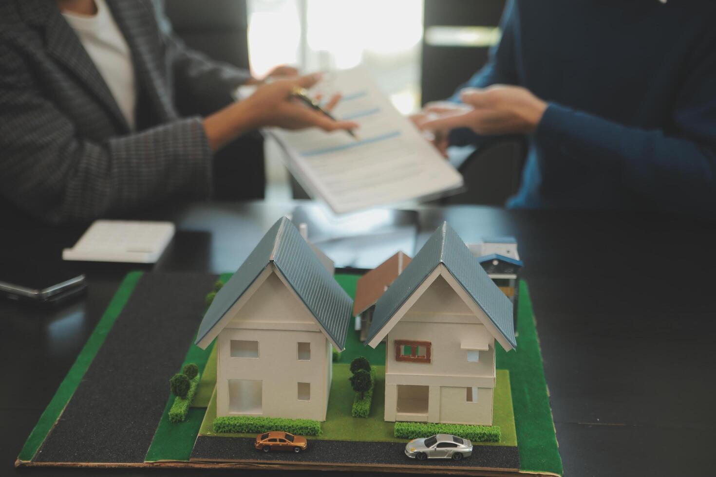 Team of architectures and businessmen discussing and brainstorming on floor plan modification for real estate investment and housing development project photo