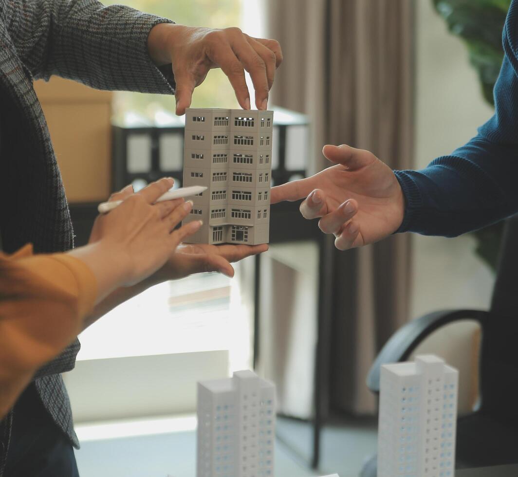 Team of architectures and businessmen discussing and brainstorming on floor plan modification for real estate investment and housing development project photo