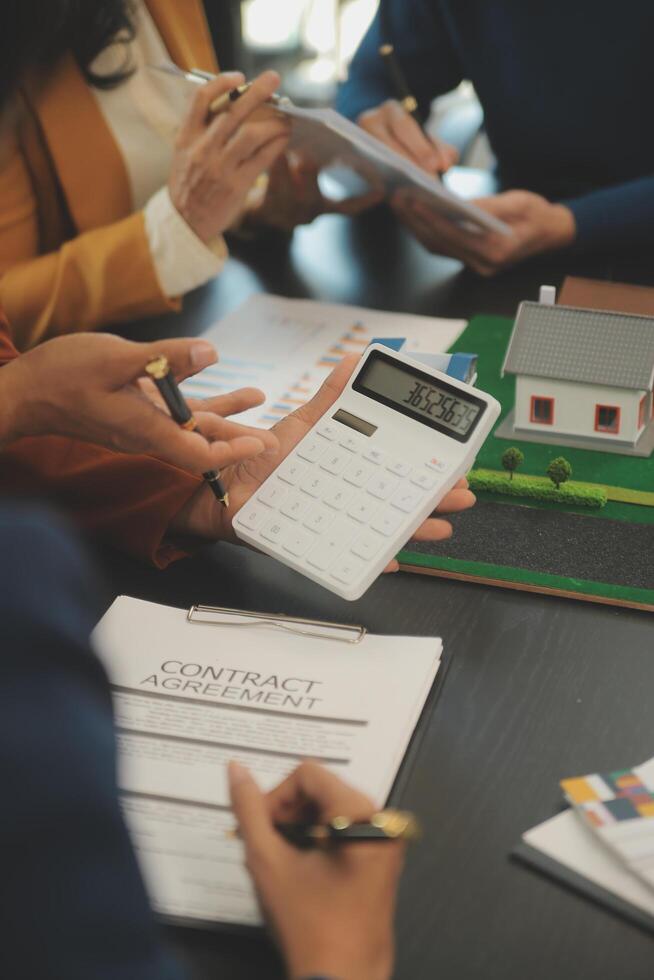Team of architectures and businessmen discussing and brainstorming on floor plan modification for real estate investment and housing development project photo
