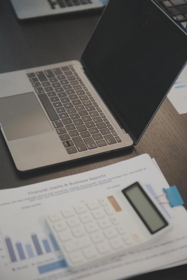 Laptop on a desk in an open financial office. photo