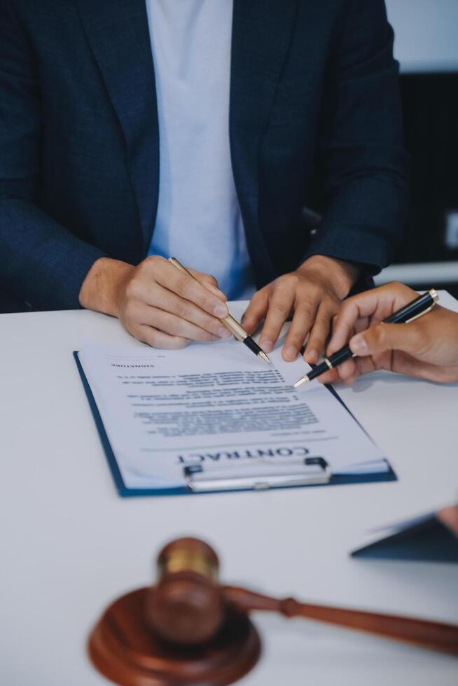 Consultation and conference of Male lawyers and professional businesswoman working and discussion having at law firm in office. Concepts of law, Judge gavel with scales of justice. photo