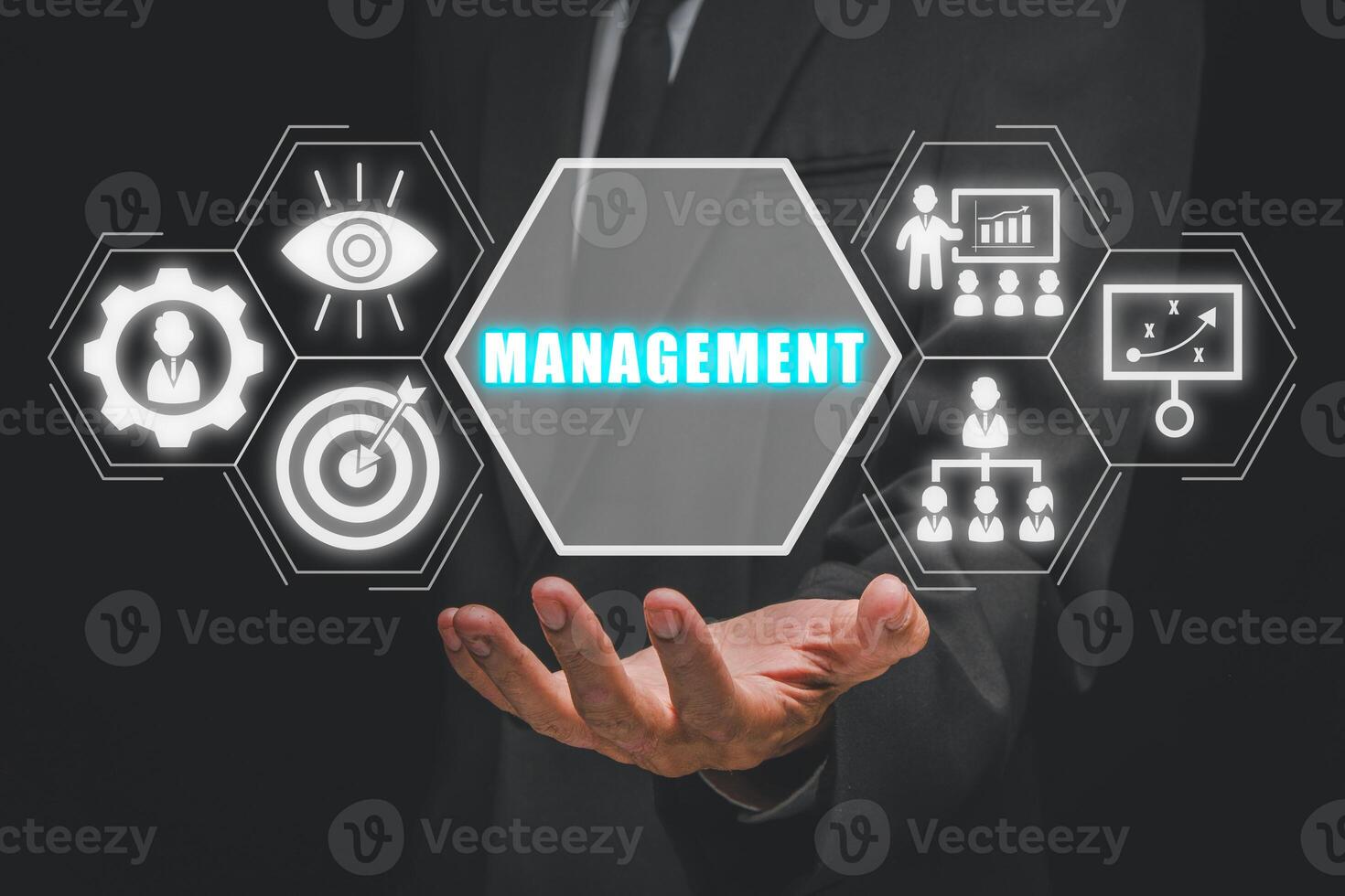 Management concept, Businessman hand holding management icon on virtual screen. photo