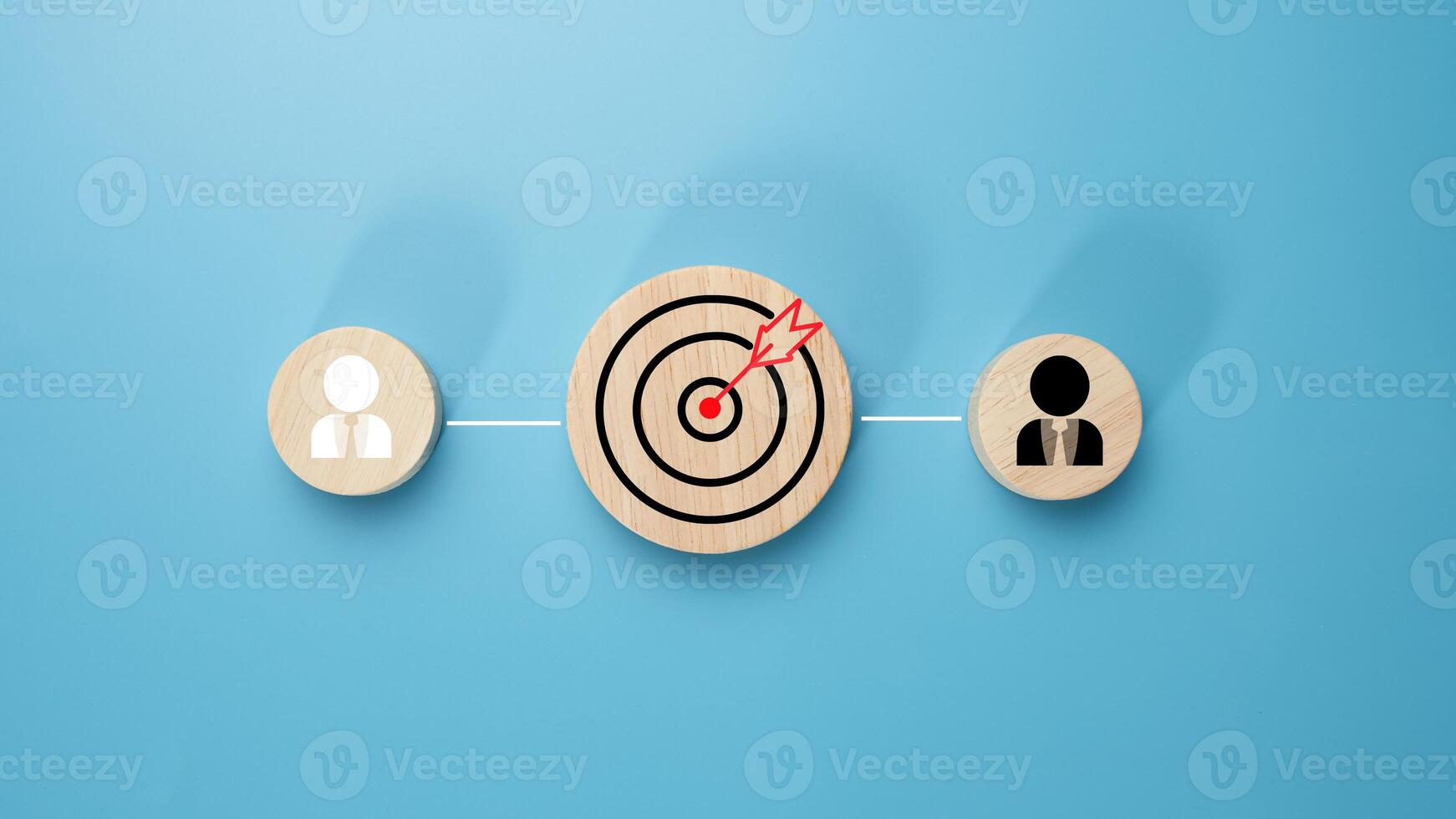 Circular wood with printed target icons and business symbols on light blue background, business goals and objectives concept, business competition, Customer relationship management concept. photo