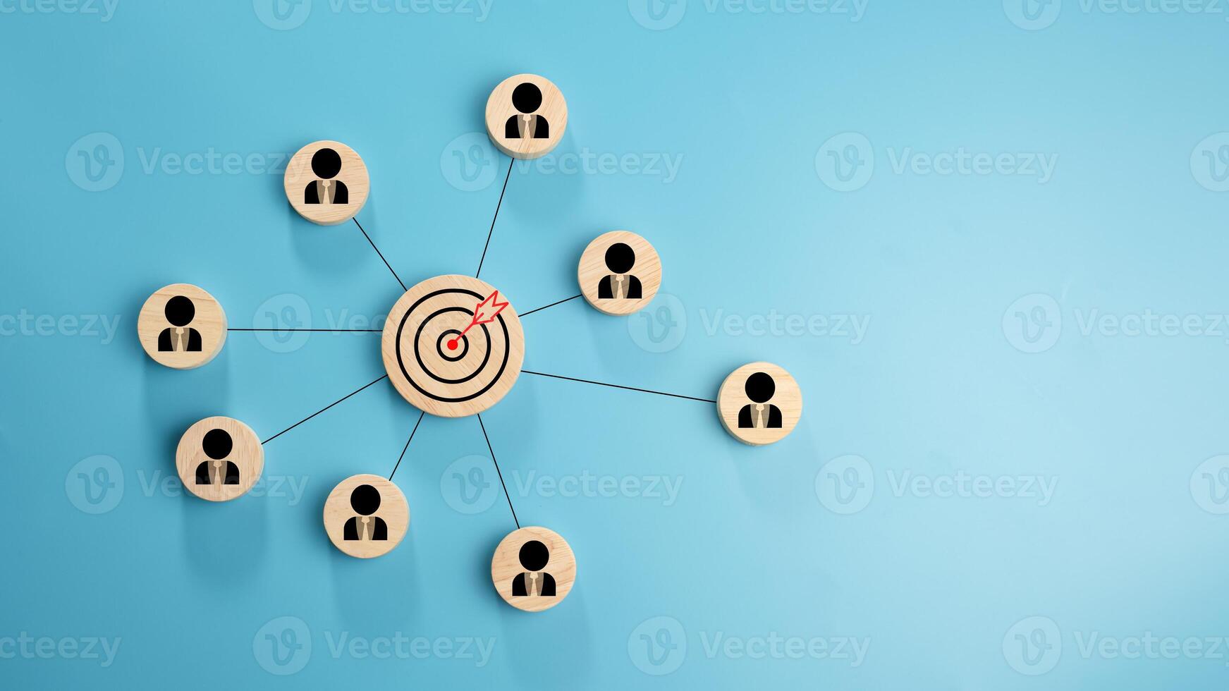 Circular wood with printed target icons and business symbols on light blue background, business goals and objectives concept, business competition, Customer relationship management concept. photo