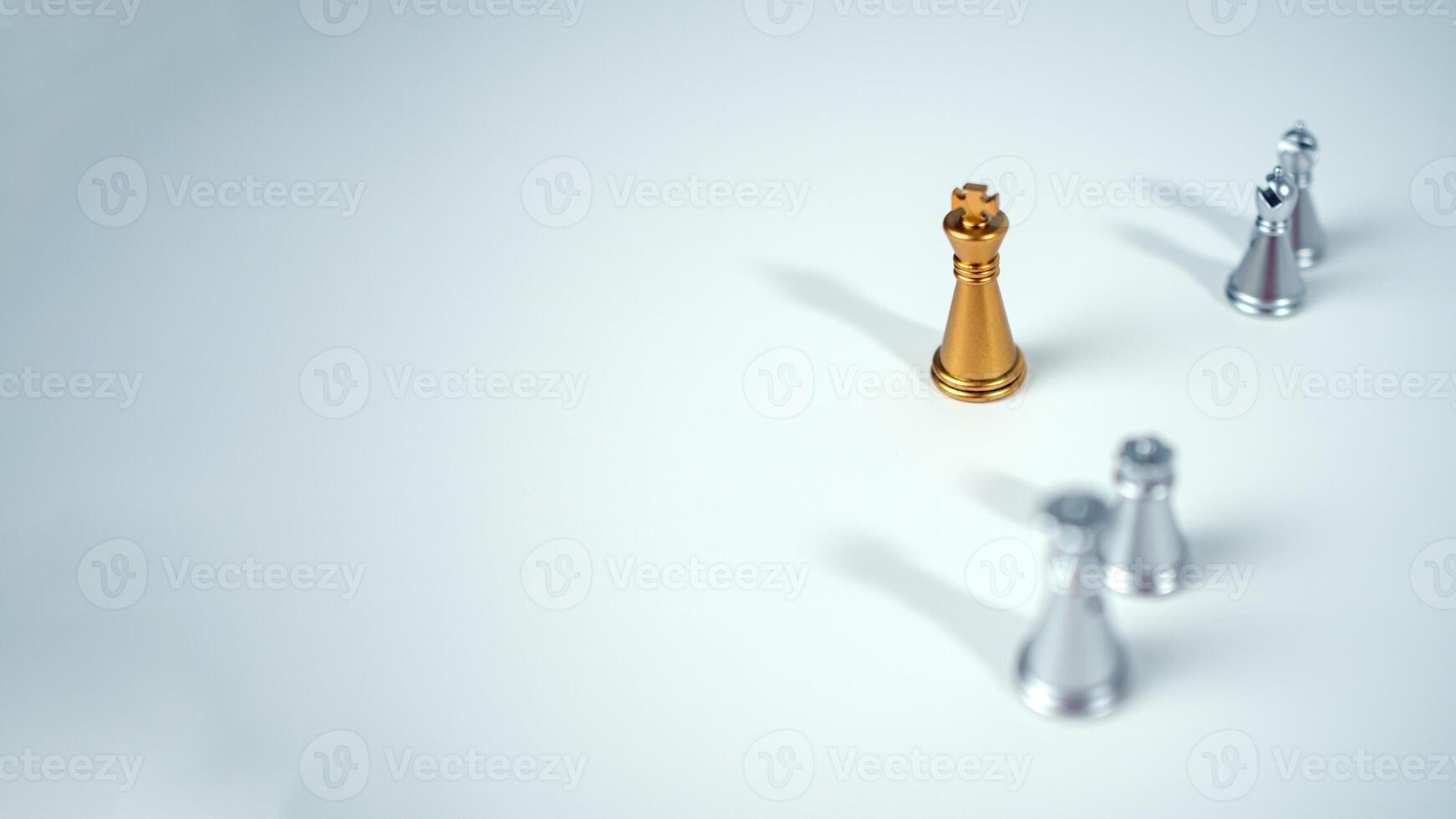 Golden king chess on the board in front of silver chess pieces on white background with copy space, Leadership, fighter, business leadership, competition, confrontation, and business strategy concept. photo