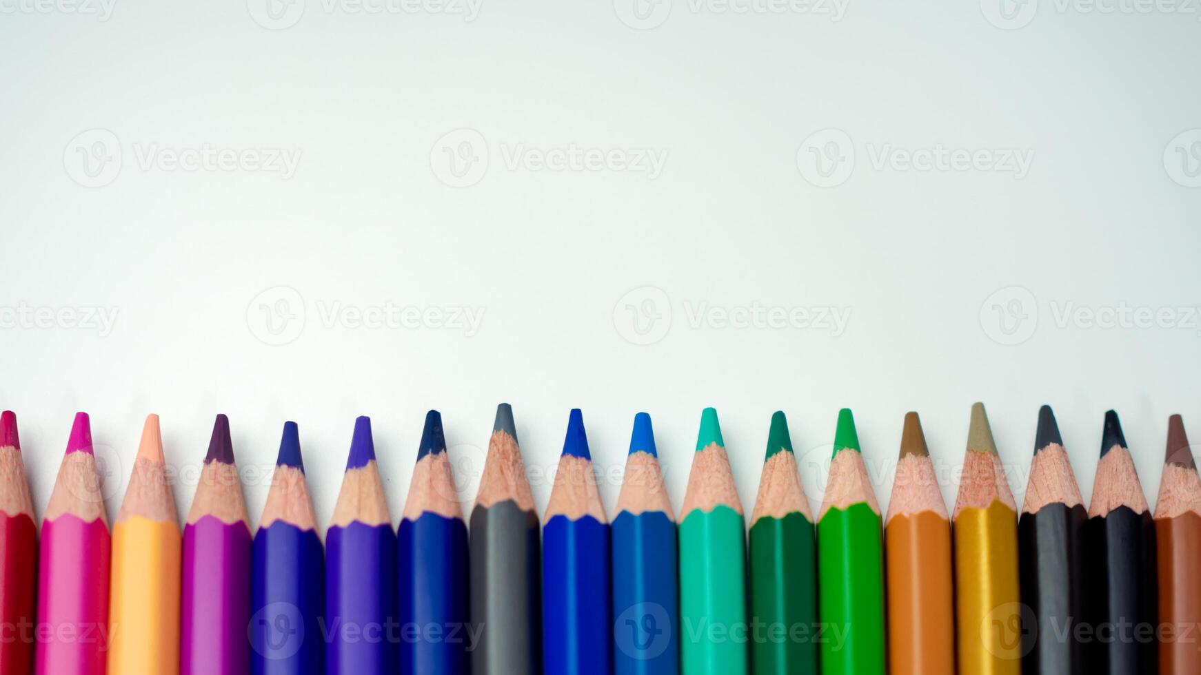 Set of colored pencils on a white background That is arranged in a bar graph, Color pencils on white background, Close up, seamless colored pencils row with wave on lower side, line pencils. photo