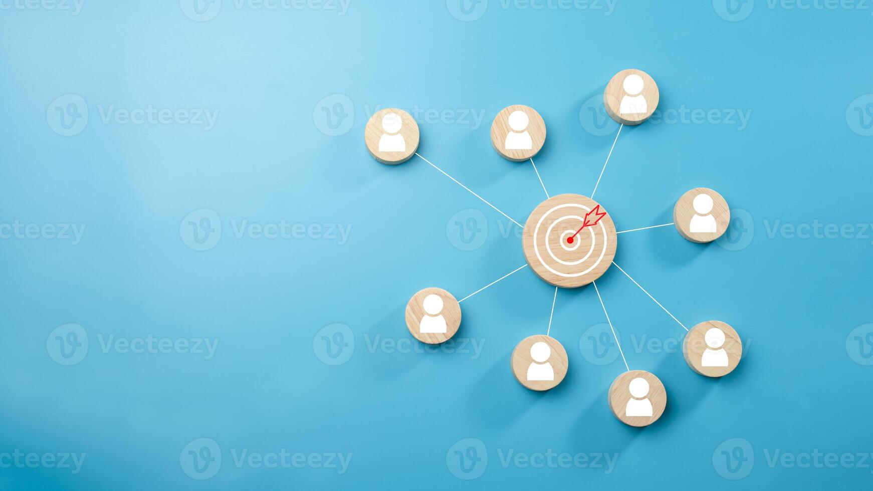 Circular wood with printed target icons and business symbols on light blue background, business goals and objectives concept, business competition, Customer relationship management concept. photo