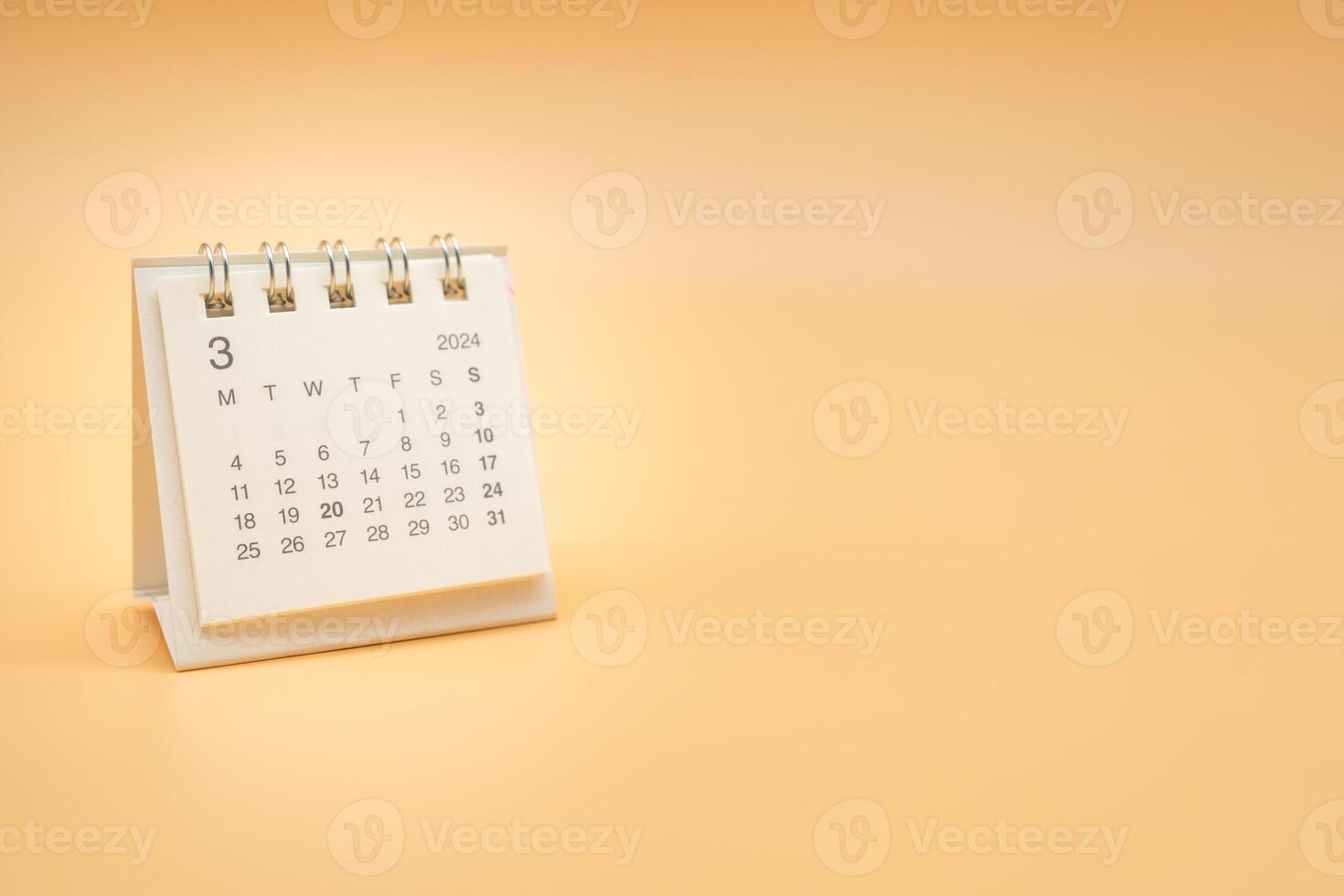 Simple desk calendar for MARCH 2024 isolated on orange background. Calendar concept with copy space. photo