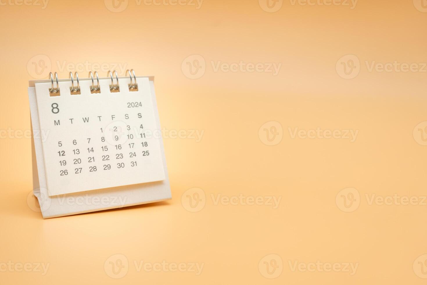 Simple desk calendar for August 2024 isolated on orange background. Calendar concept with copy space. photo