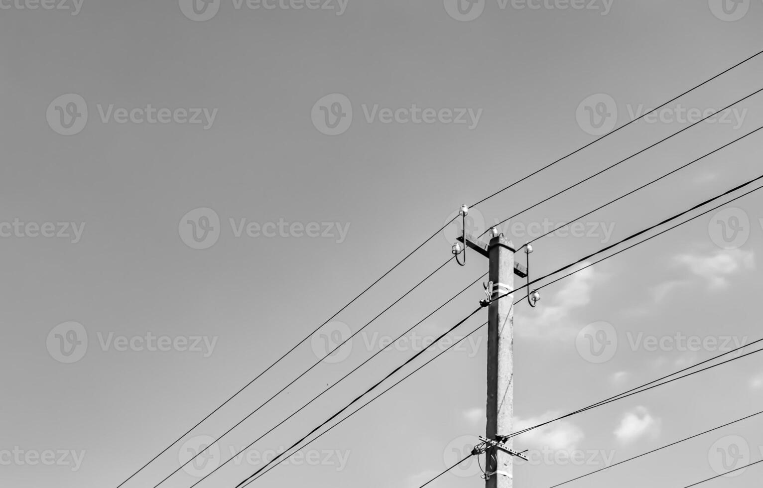 Power electric pole with line wire on light background close up photo