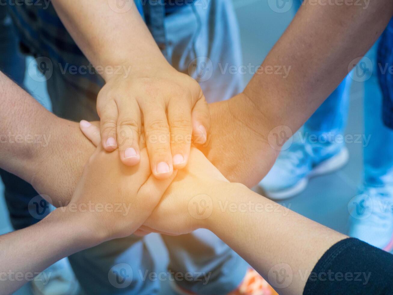 Top view of hands joined together. Concept of unity and teamwork photo