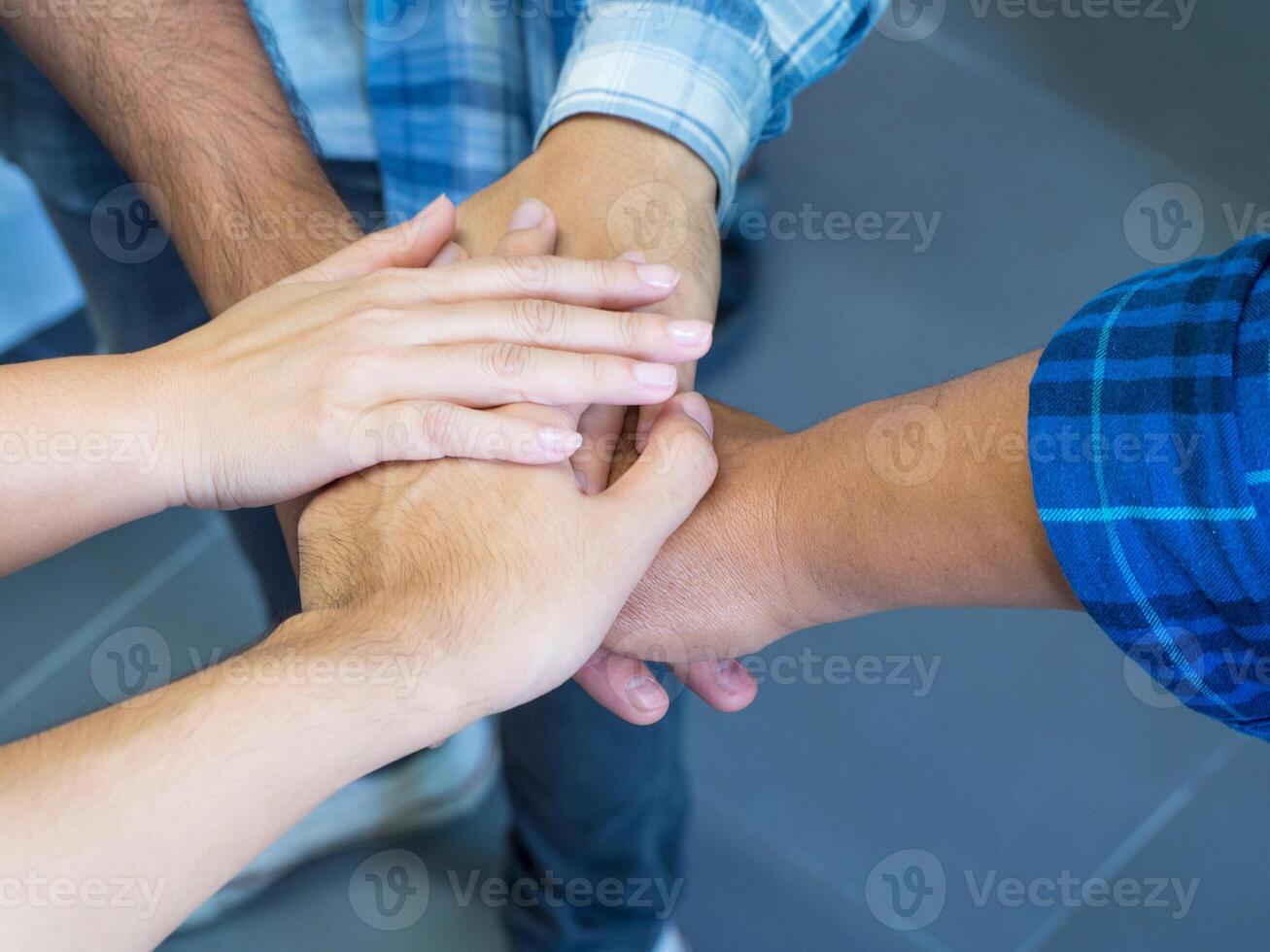 Top view of hands joined together. Concept of unity and teamwork photo