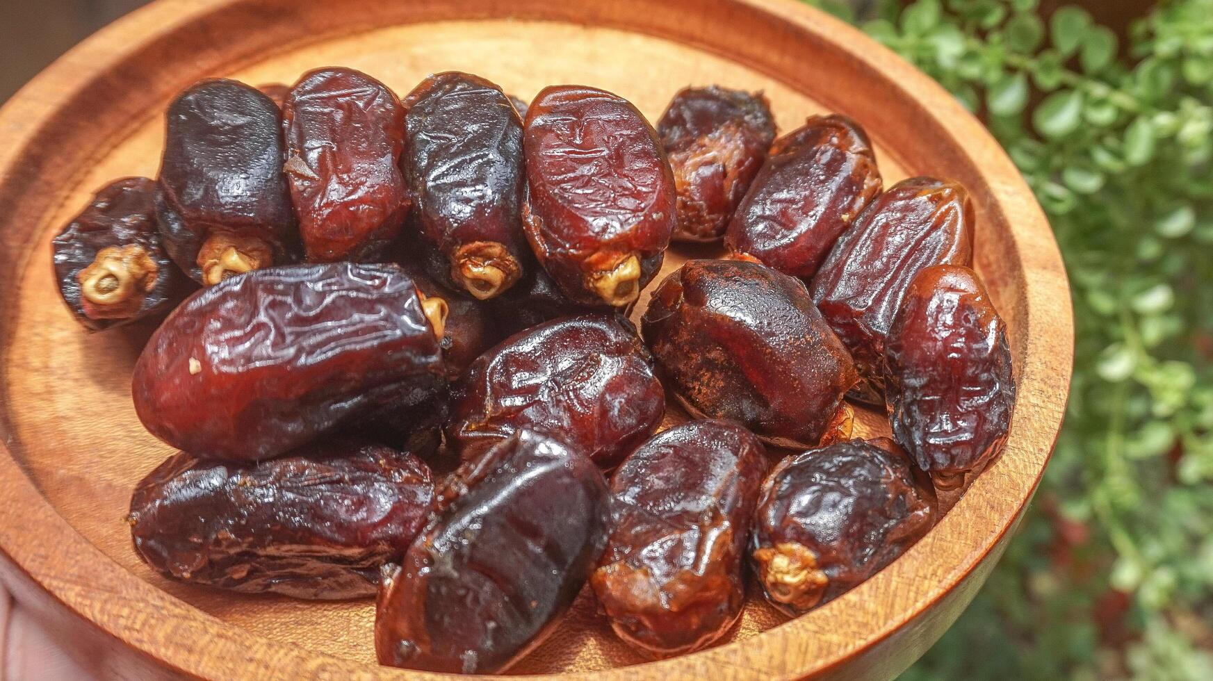 closeup sweet dried date palm fruits or kurma, ramadan food photo