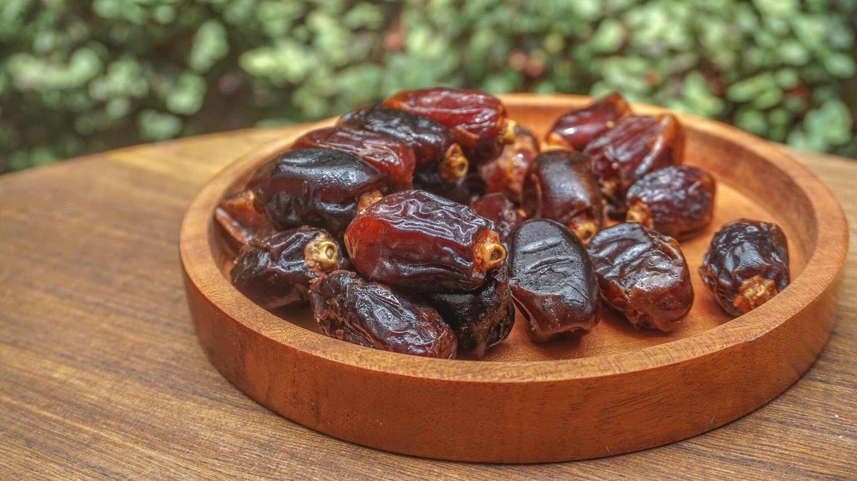 closeup sweet dried date palm fruits or kurma, ramadan food photo