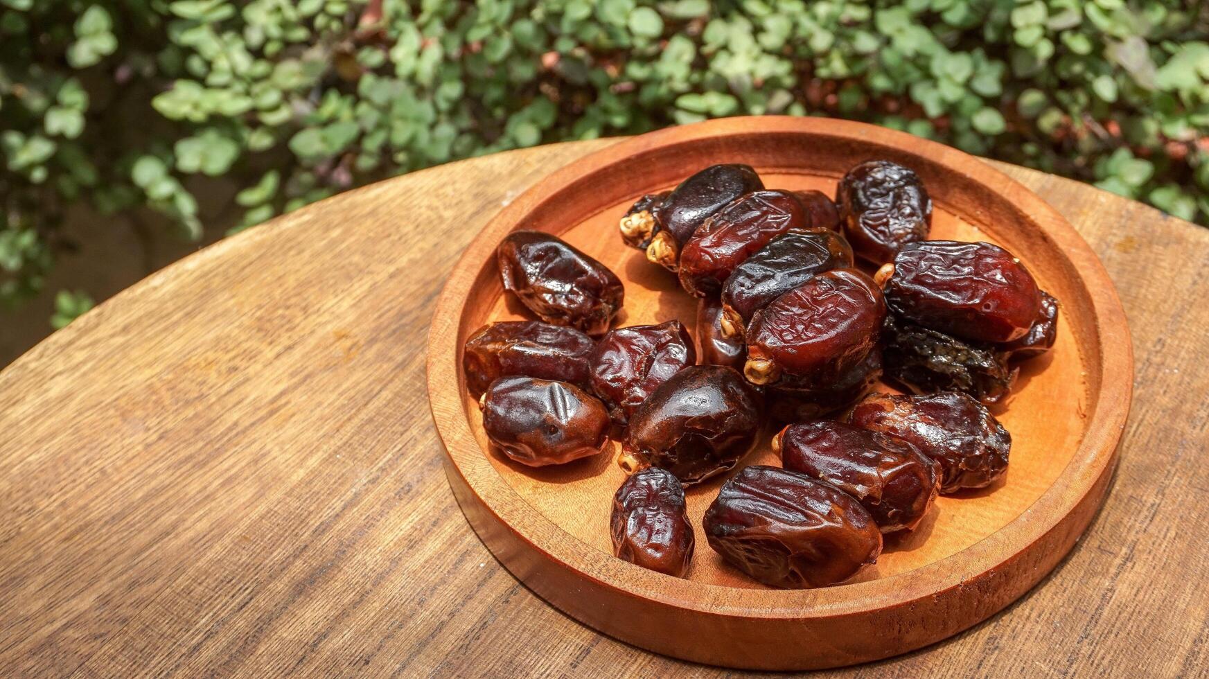 closeup sweet dried date palm fruits or kurma, ramadan food photo