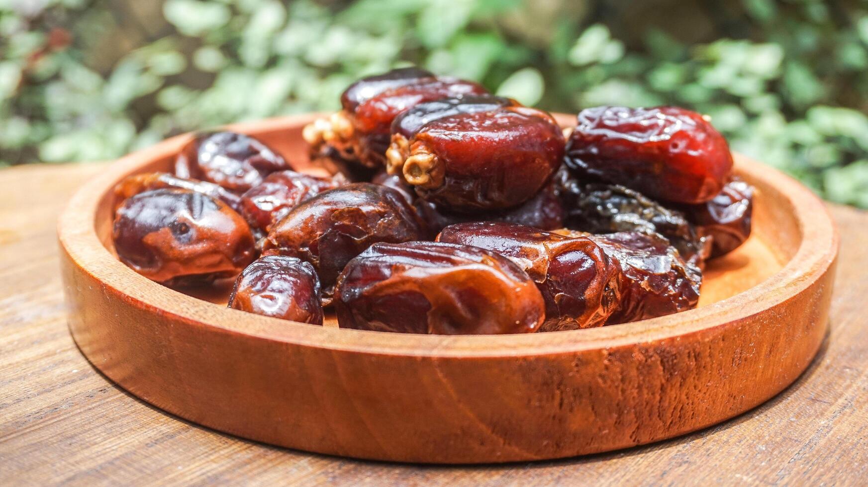 closeup sweet dried date palm fruits or kurma, ramadan food photo