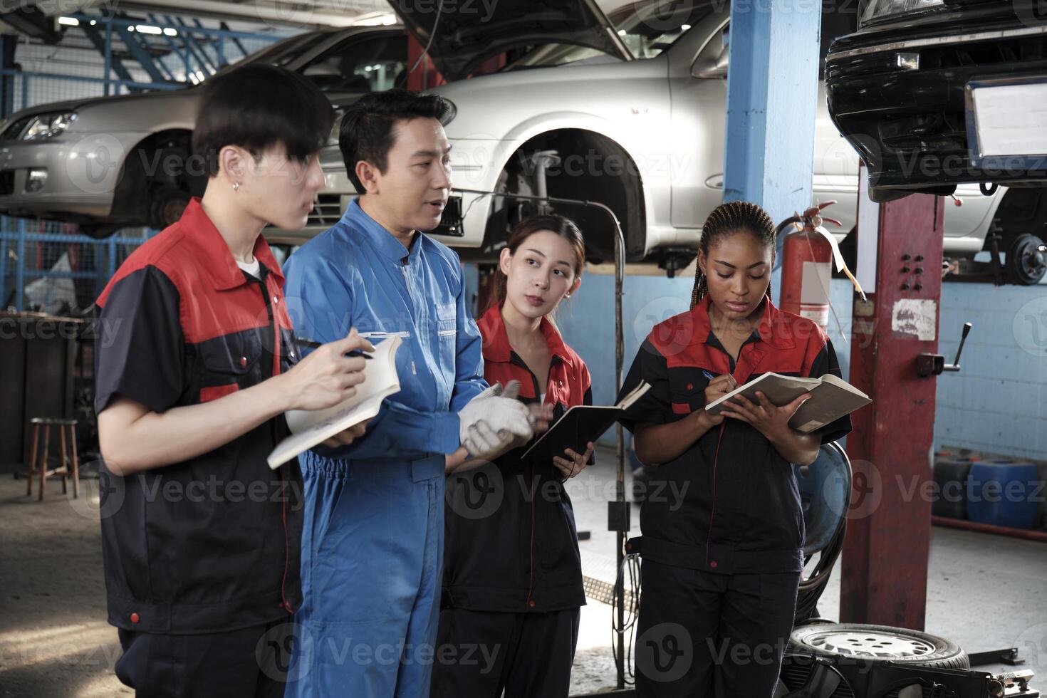 Specialist lecture. Male supervisor engineer describe automotive suspension fixing with mechanic worker staff teams for repair work at car service garage and maintenance jobs in automobile industry. photo