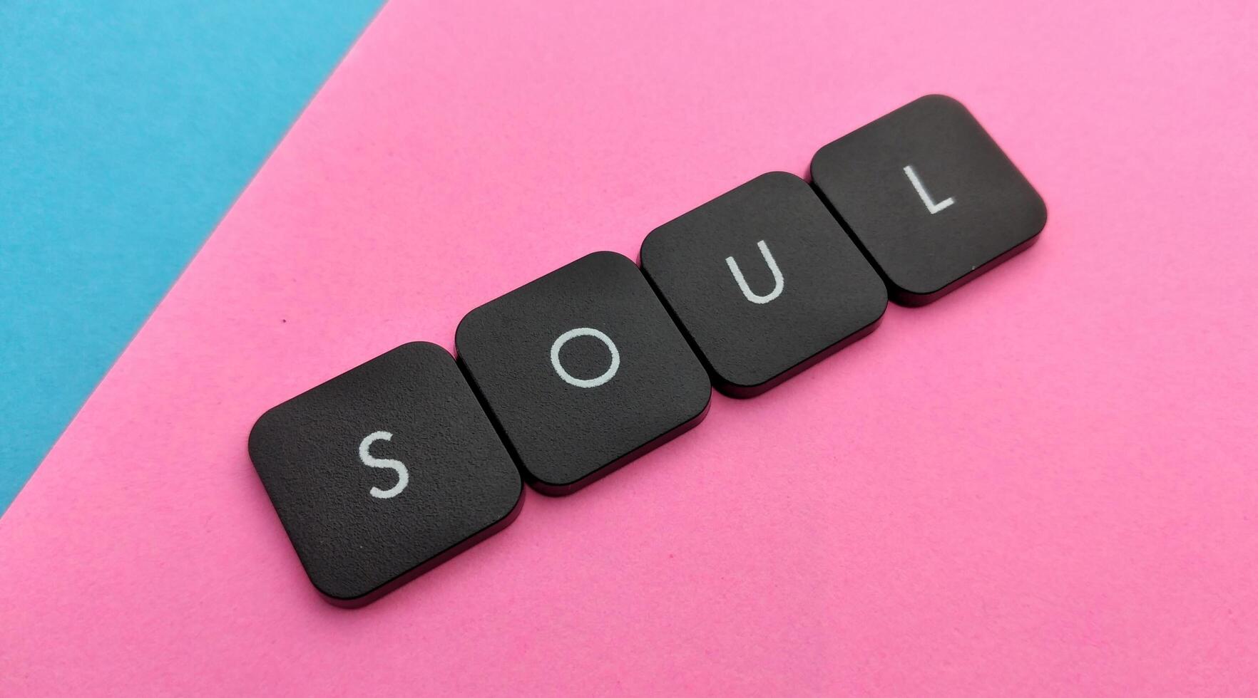 SOUL word in black letters on pink and blue background. photo