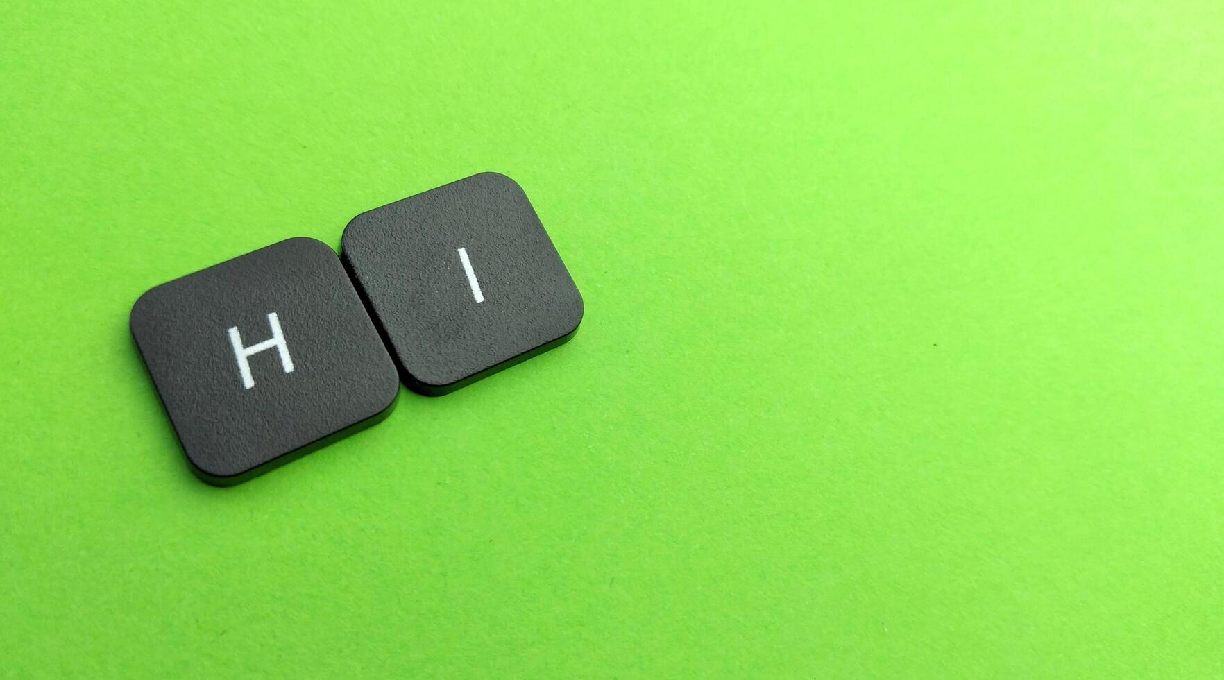 word hi keyboard on green background photo