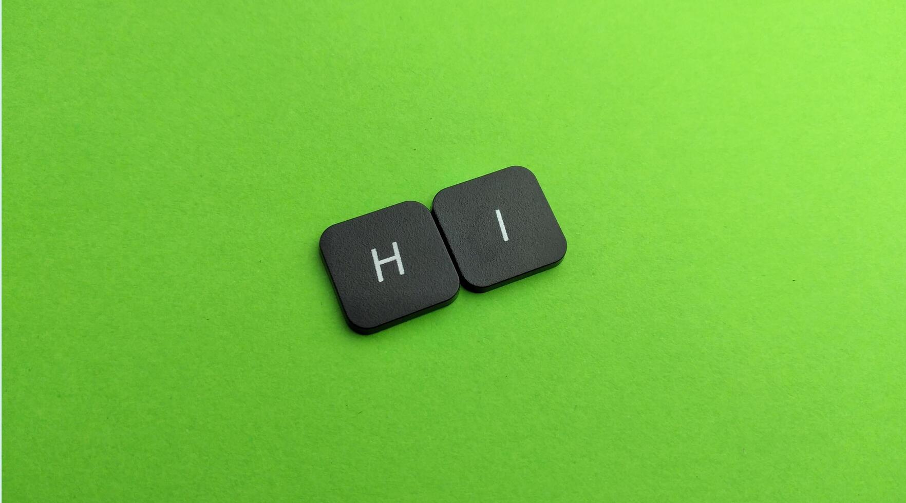 word hi keyboard on green background photo