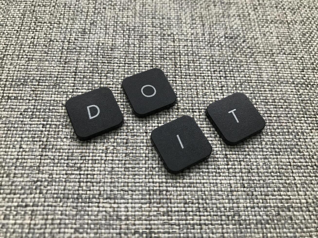Do it text on grey carpet. Motivational and inspirational background. photo