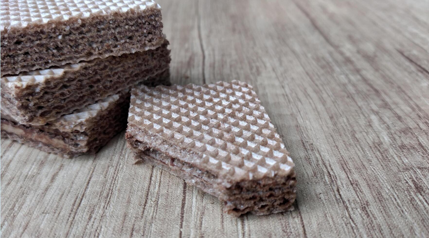 Chocolate wafers on wooden background. Selective focus. photo