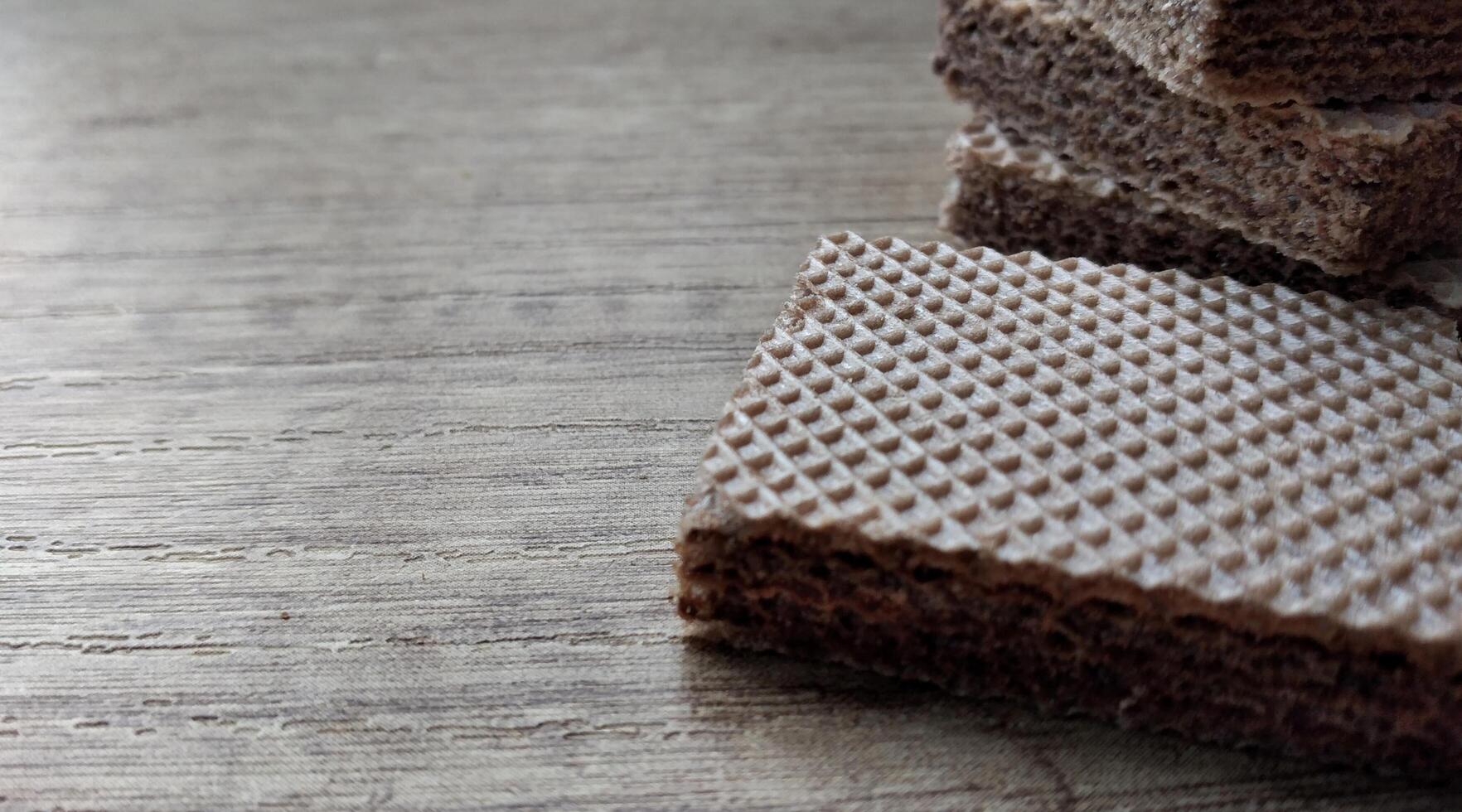 Chocolate wafers on wooden background. Selective focus. photo
