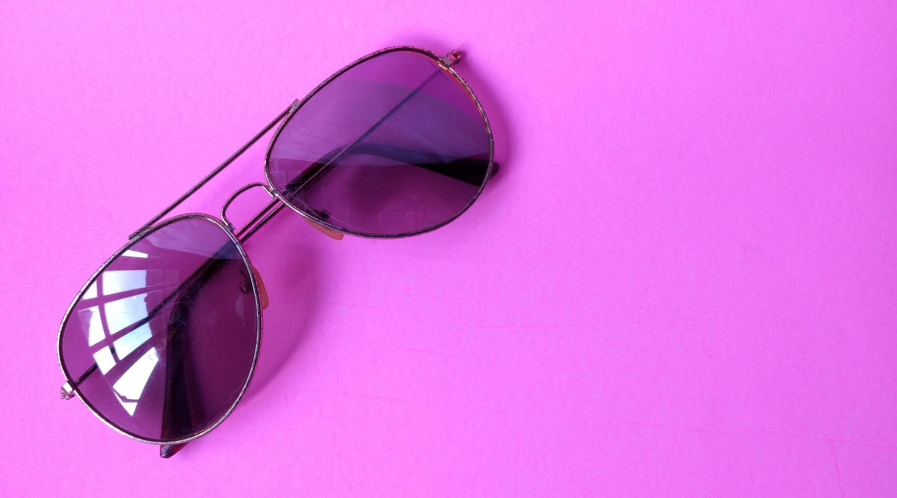 Glasses on a pink background. View from above. Place for text. photo