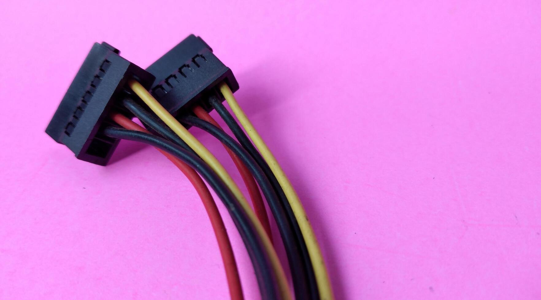 Close up of computer cable isolated on pink background with copy space. photo