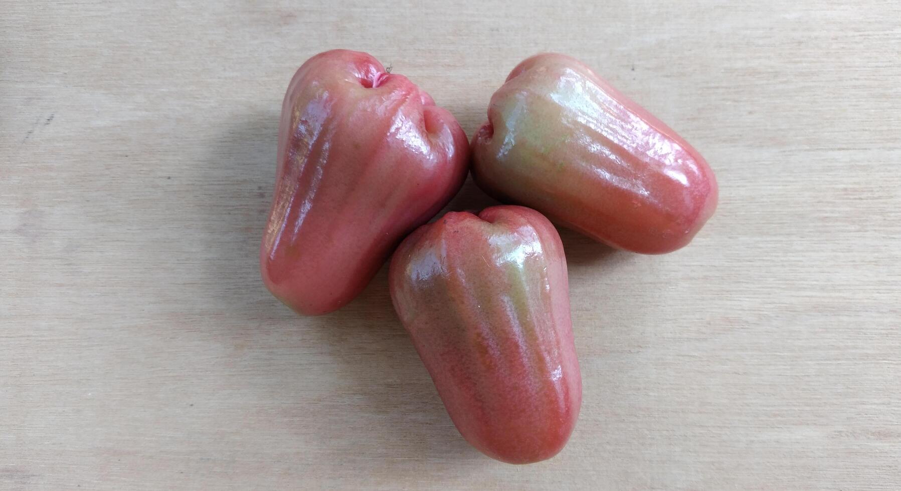 Rose apple on wood background, top view of fresh rose apple. photo