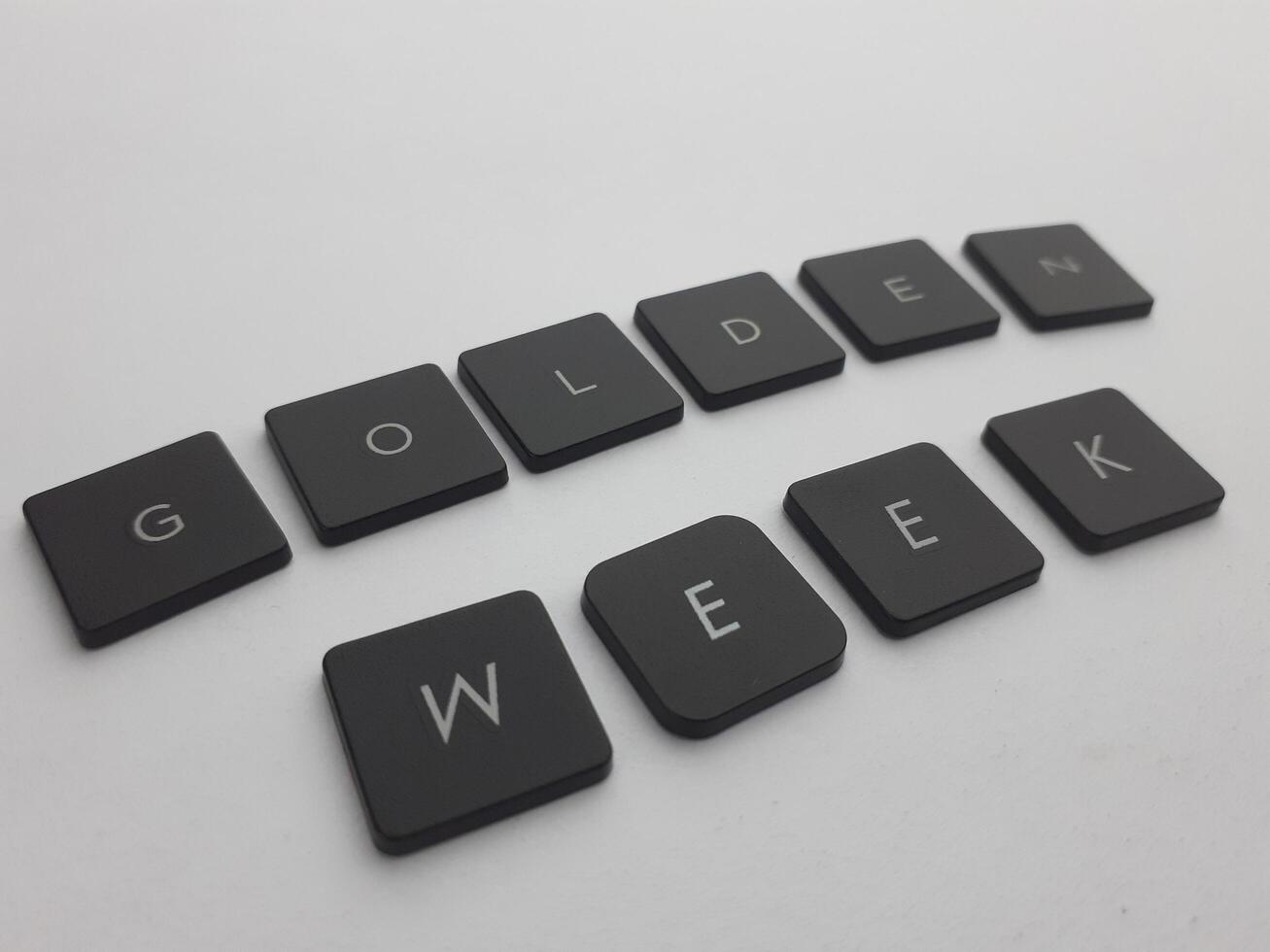 Keyboard with the word golden week written in black on a white background photo
