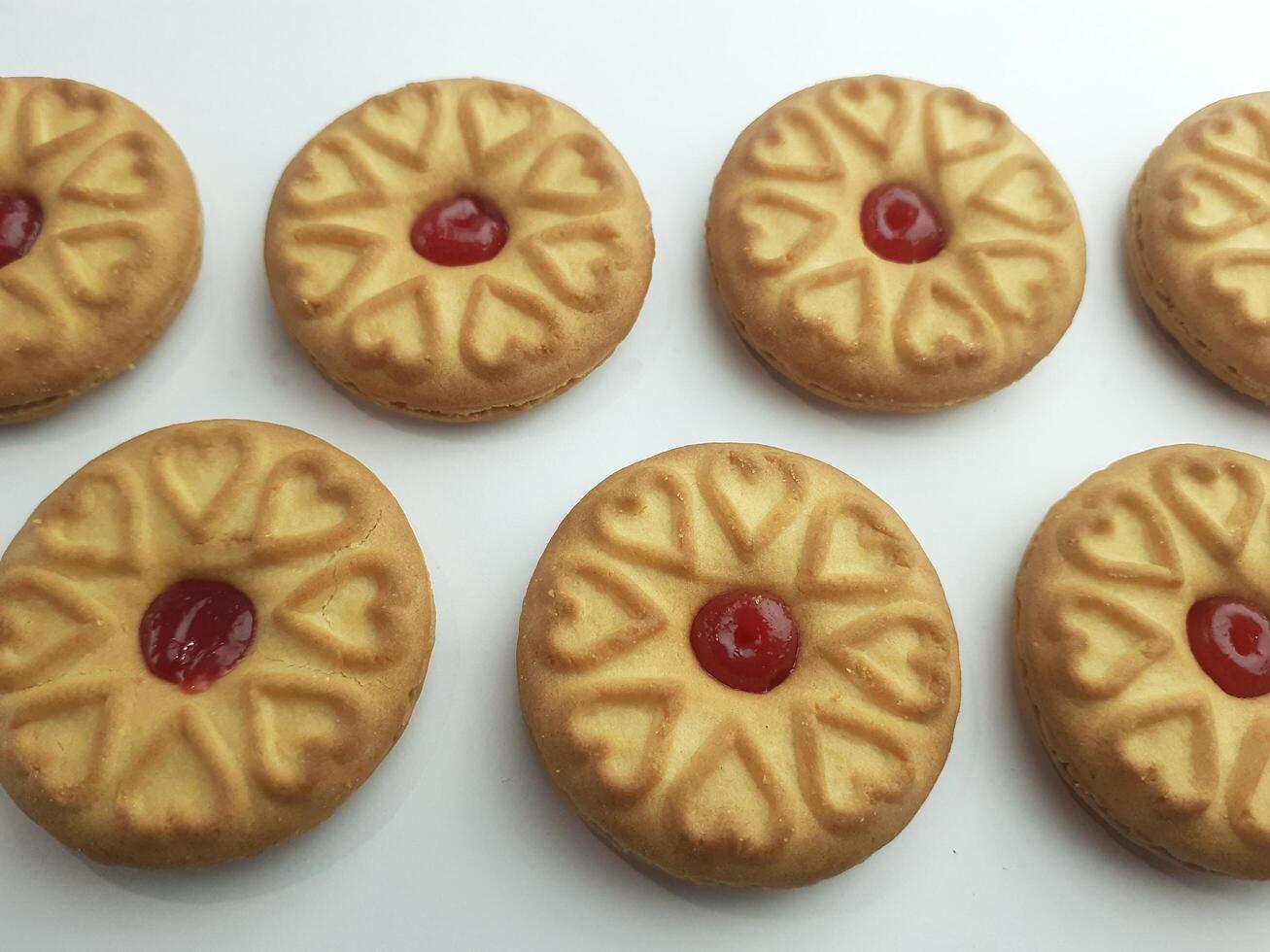 cookies with strawberry jam on a white background, close up photo