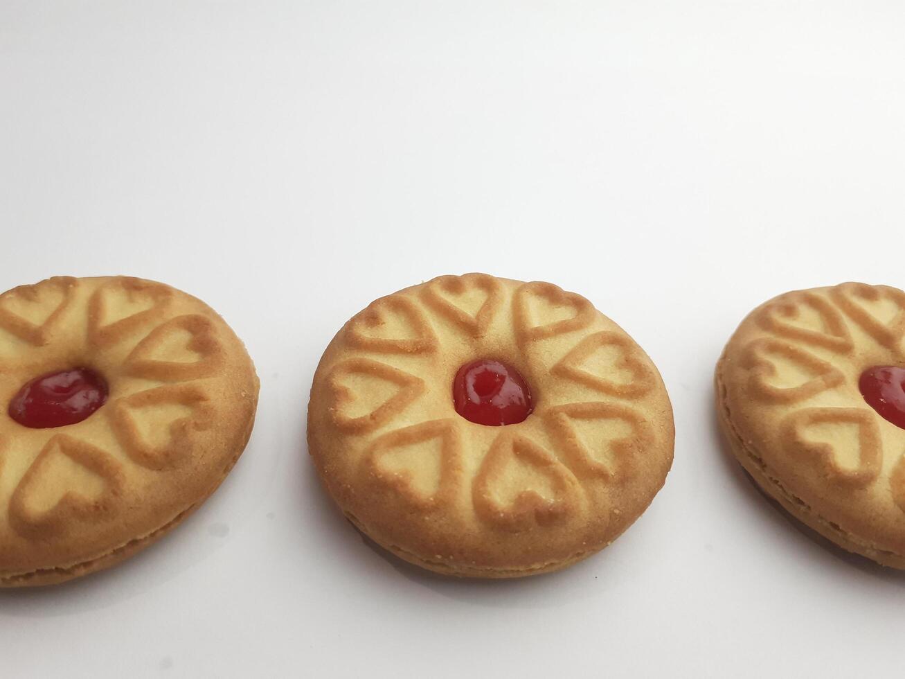cookies with strawberry jam on a white background, close up photo