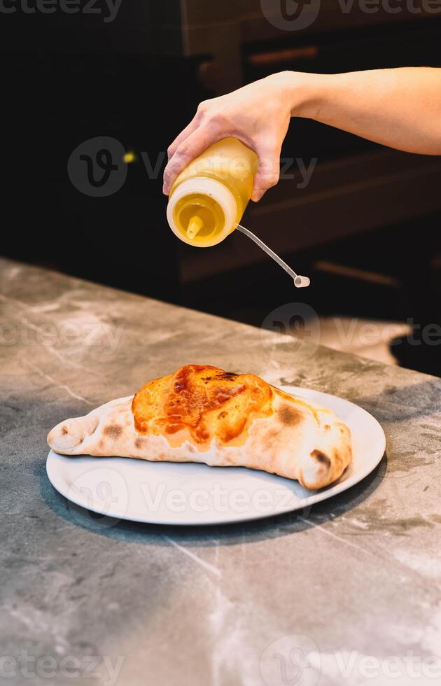 Traditional Italian calzone made with fresh dough in a wood-fired oven photo