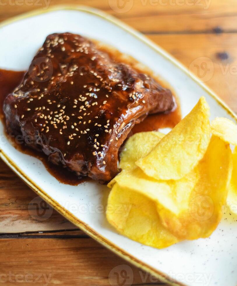 Pork ribs with sweet and sour barbecue sauce photo