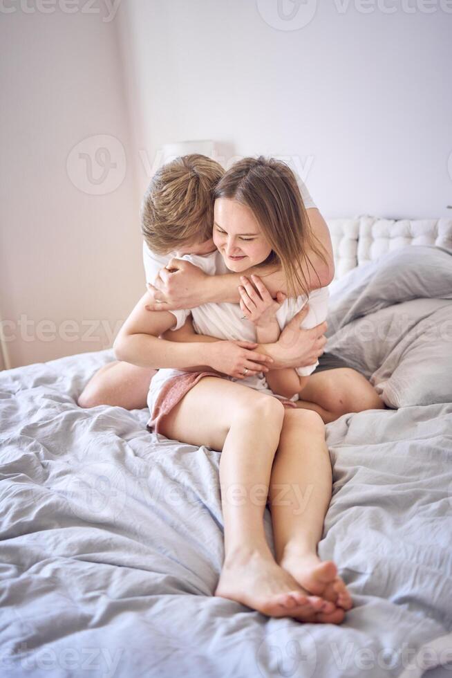 tender embrace of young man and woman at home photo