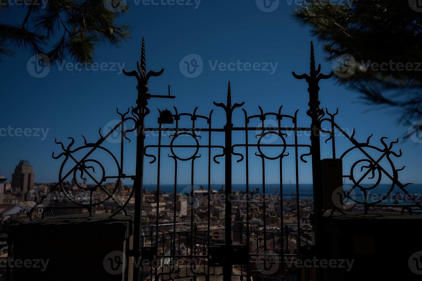 a beautiful wrought iron gate in the foreground of a top view of genoa photo