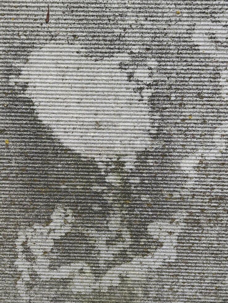 background, texture of ribbed cement fence with flames from rain and lichen, grunge photo