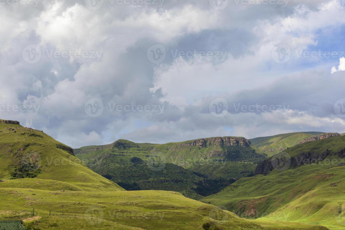 Blue clouds over green mountains photo