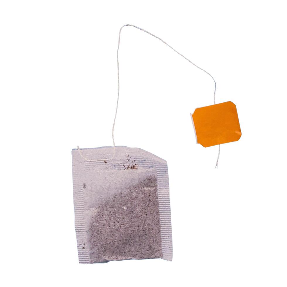 Teabag with yellow label. Top view. Isolated on a white. photo