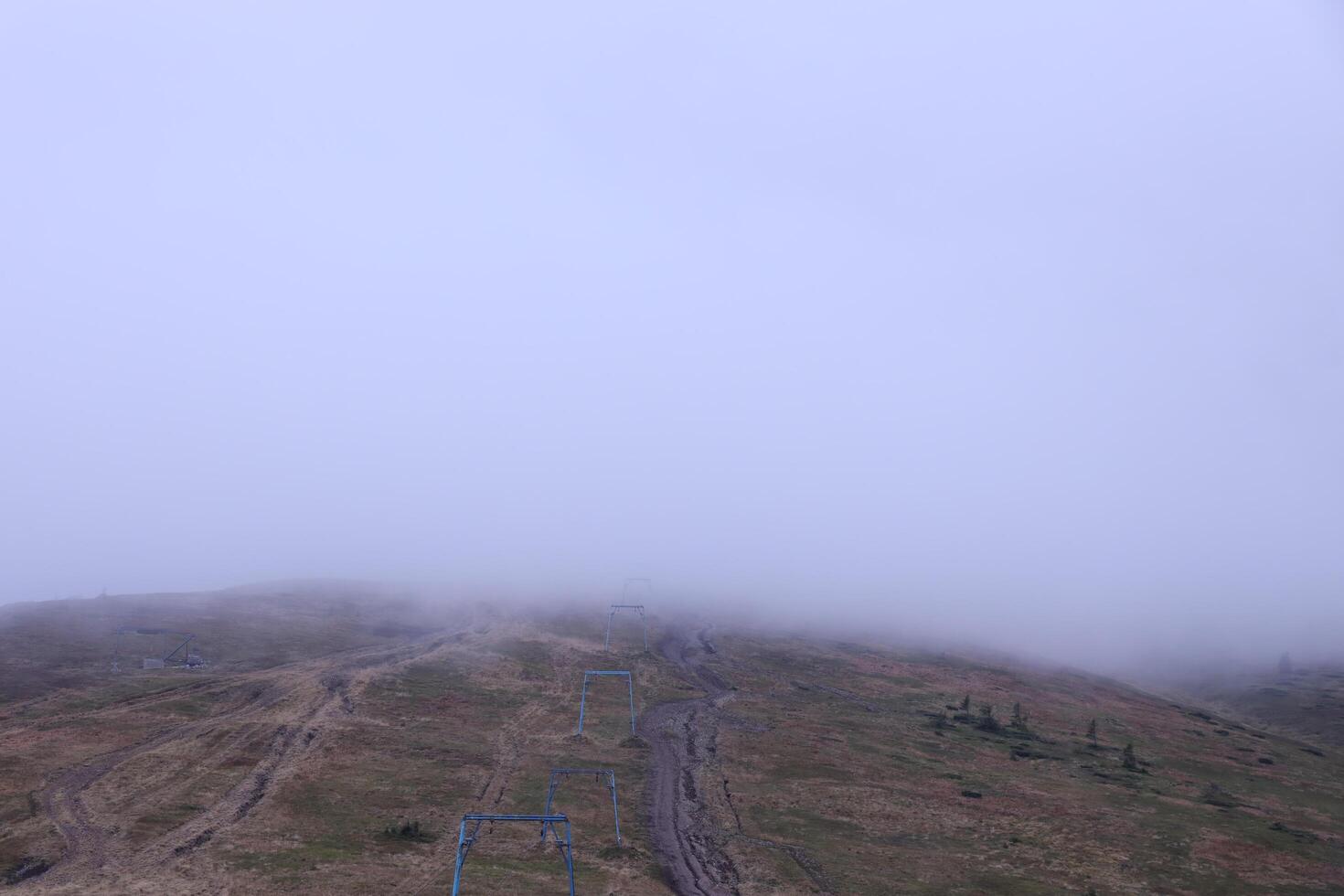 Morning view from the Dragobrat mountain peaks in Carpathian mountains, Ukraine. Cloudy and foggy landscape around Drahobrat Peaks photo