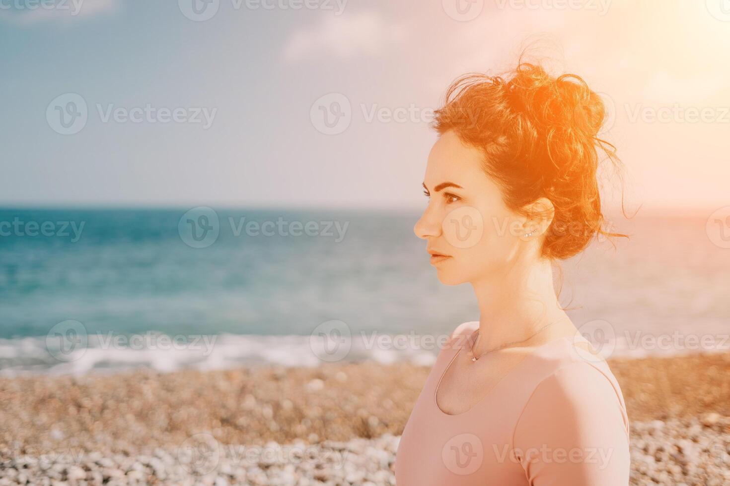 Woman sea pilates. Sporty happy middle aged woman practicing fitness on beach near sea, smiling active female training with ring on yoga mat outside, enjoying healthy lifestyle, harmony and meditation photo