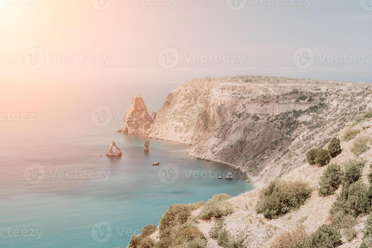 Aerial view from above on calm azure sea and volcanic rocky shores. Small waves on water surface in motion blur. Nature summer ocean sea beach background. Nobody. Holiday, vacation and travel concept photo