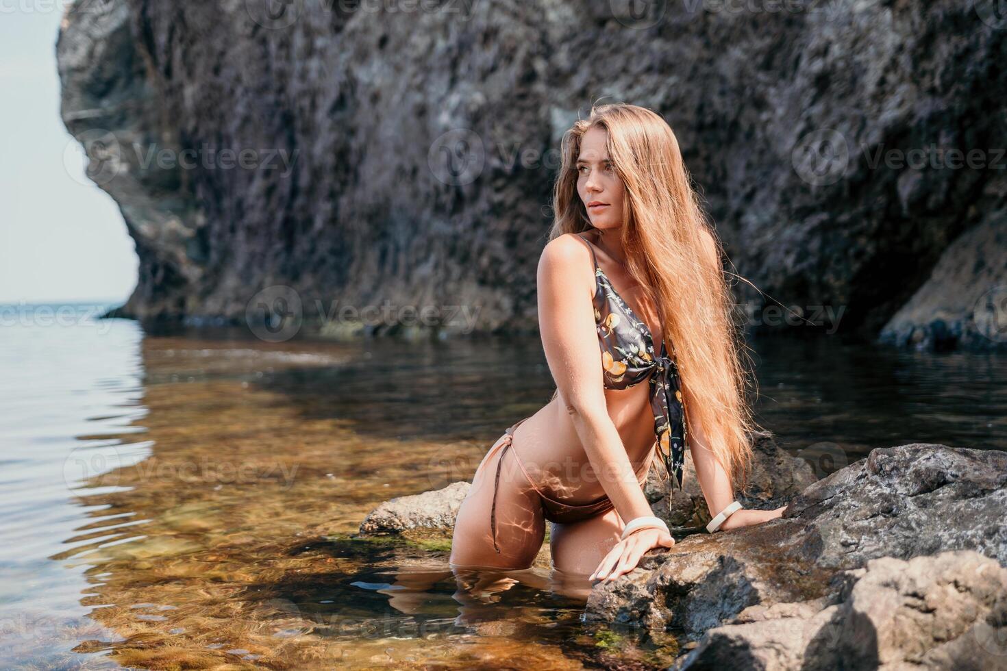 Woman travel sea. Happy tourist enjoy taking picture outdoors for memories. Woman traveler swim in the sea bay with mountains, sharing travel adventure journey photo